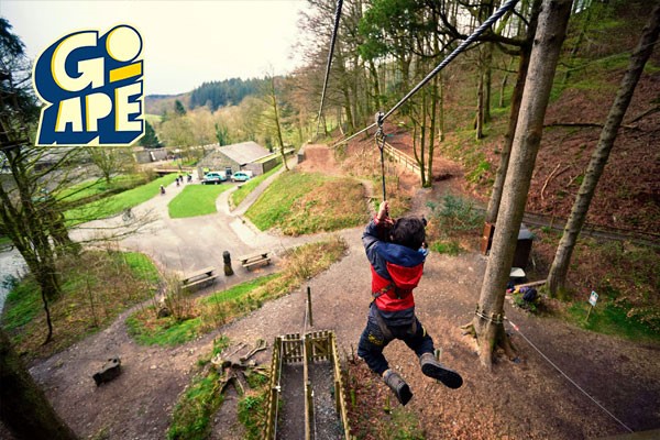 A child swining on the zip line through the trees in Go Ape, Bournemouth