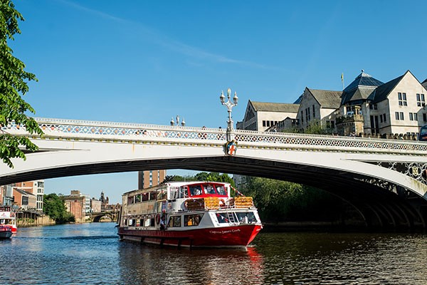 Boat going under the bridge on River Ouse in York