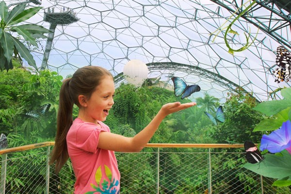 Girl holding a butterfly at the Eden Project in Cornwall
