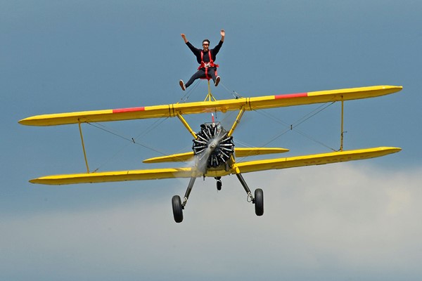 A person taking to the skies with a wingwalking experience on top of the plane
