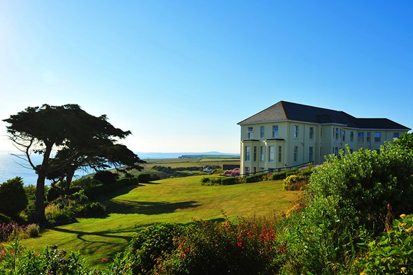 Coastal Cornish hotel with sea views on a sunny day