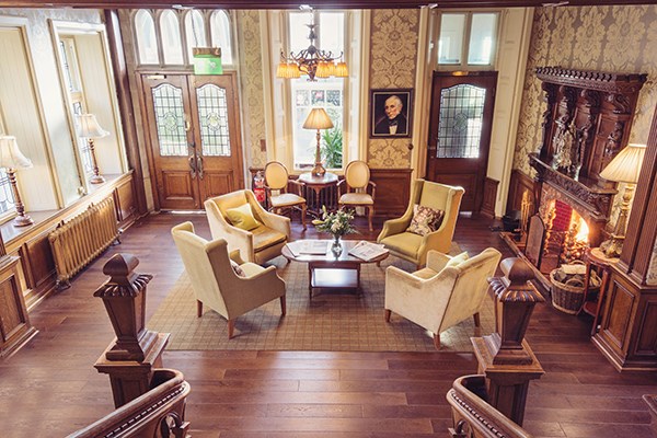 Four Chairs Close to an Open Fire In Period Living Room at Merewood Country House, Lake District