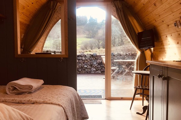 Inside of a Glamping Pod Looking Out to Green Countryside