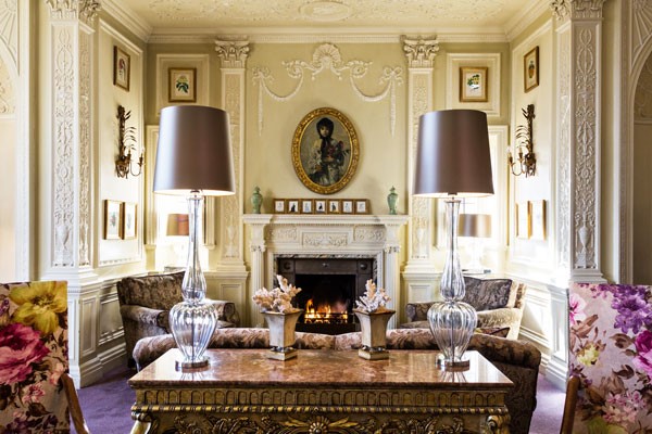 Cosy living room area with an open fire and luxury furnishings inside Bovey Castle, Devo