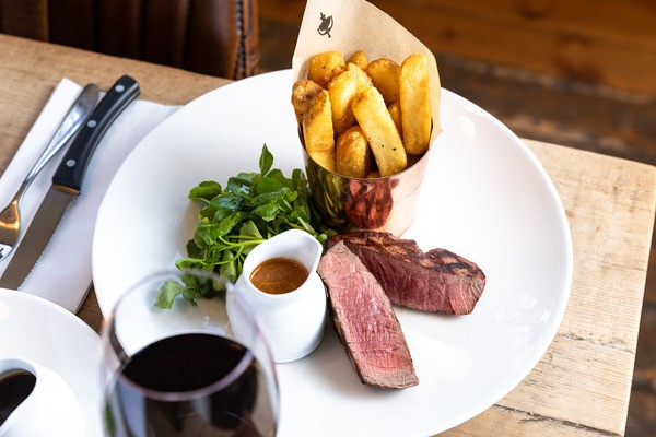 Steak with a Bottle of Wine for Two at a British Pub or Bar picture