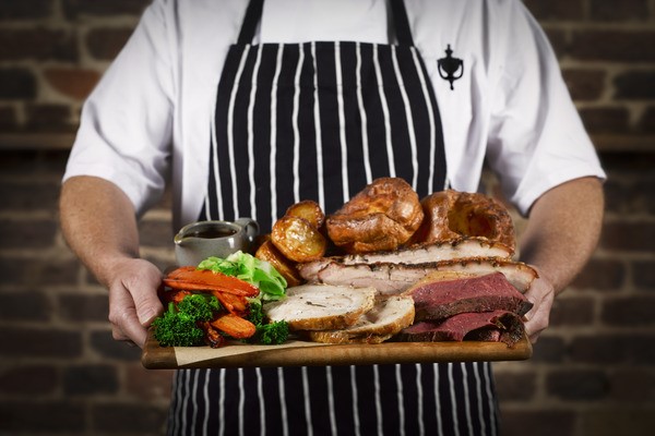 Sunday Roast Sharer with a Glass of Wine for Four at a British Pub or Bar