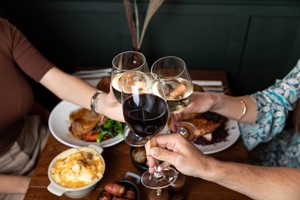 Sunday Roast Sharer with a Glass of Wine for Four at a British Pub or Bar Image 2