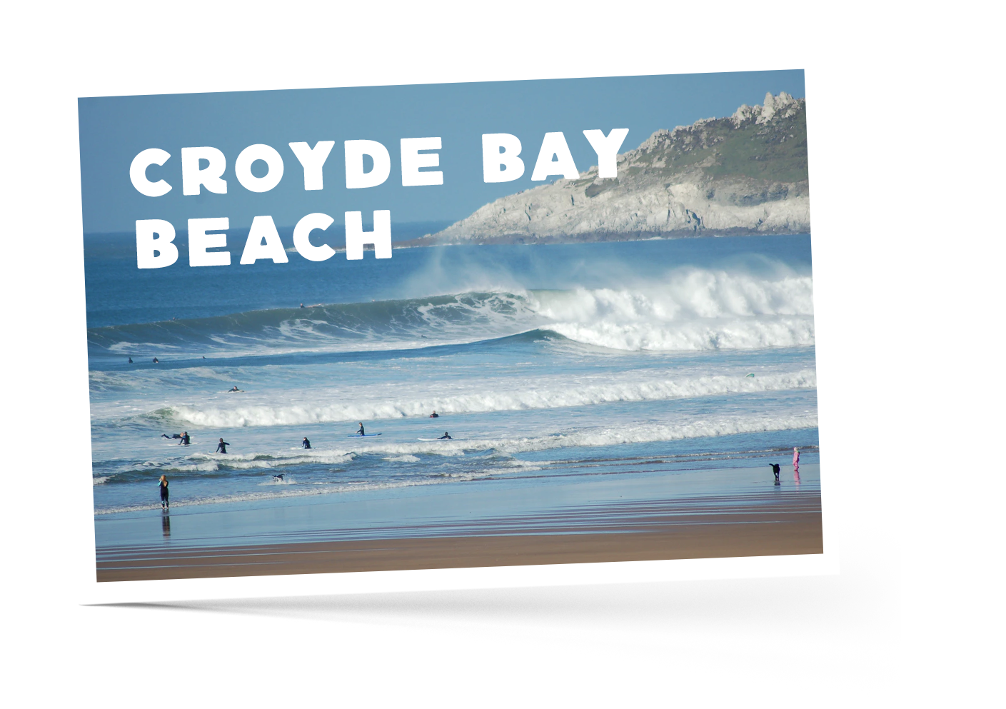 People taking a dip in the sea with bright blue waves crashing onto Croyde Bay beach