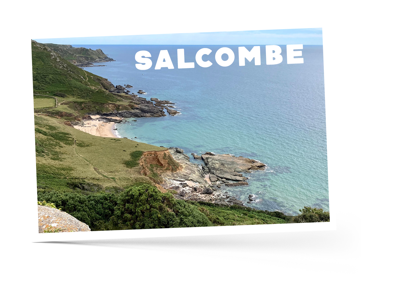 Grass covered cliffs and sandy beaches in Salcombe, Devon meeting a calm blue sea