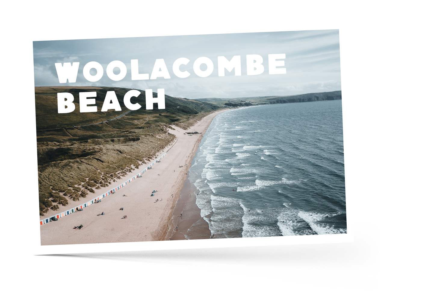 Sand dunes, a row of coloured beach huts along Woolacombe beach and deep blue sea
