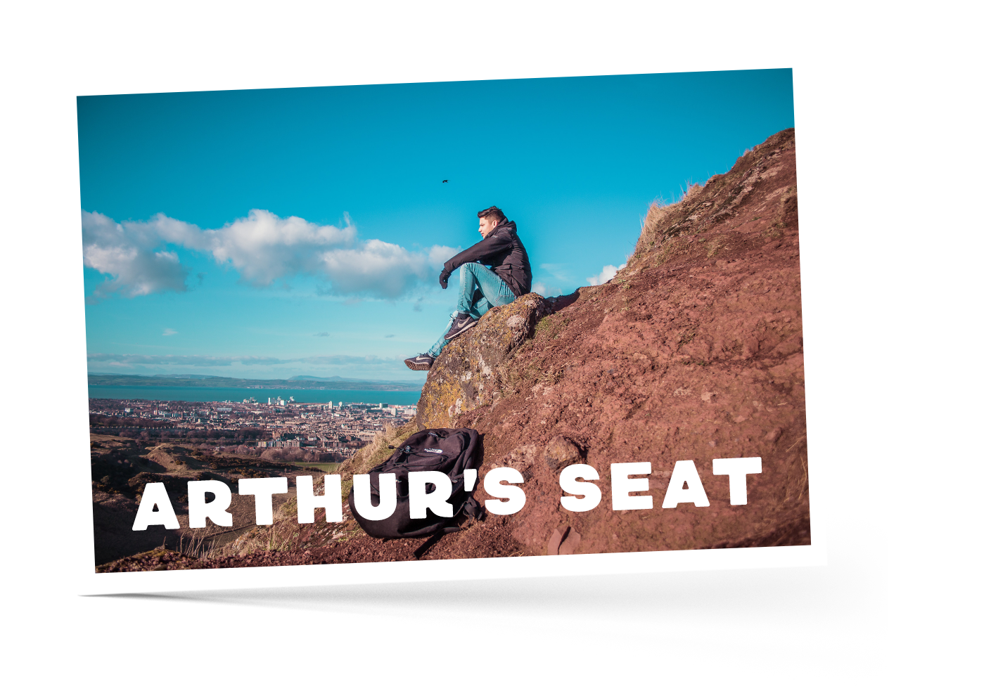 Person sitting on Arthur's Seat, Scotland, looking down at the view